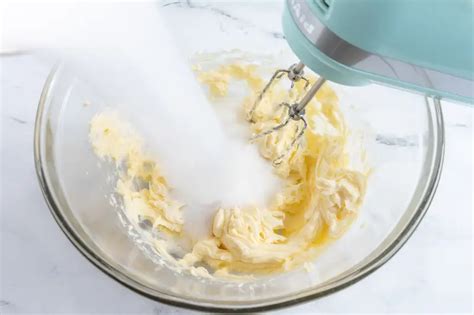 Bol avec beurre et sucre en train d'être fouettés