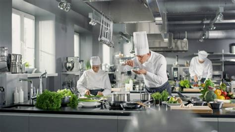 Un chef préparant une réduction complexe dans une cuisine professionnelle