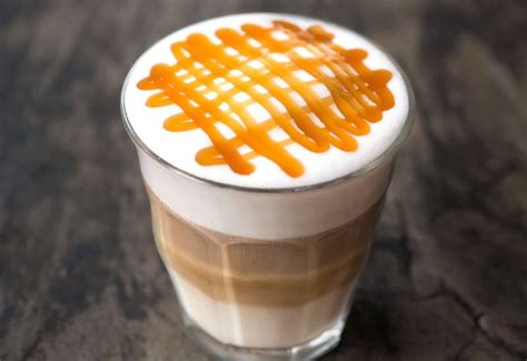 Barista décorant un Caramel Macchiato avec de la mousse de lait