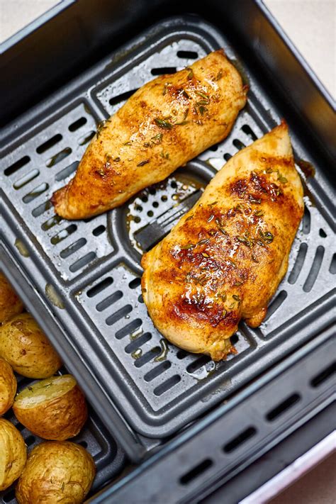 poêle en inox avec filet de poulet en train de cuire