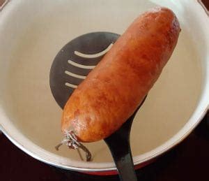 Casserole d'eau avec une saucisse de Morteau crue