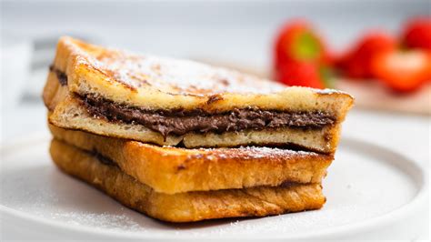 Nutella jar next to a French Toast sandwich