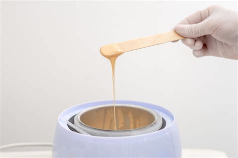 Schéma d'application de cire chaude avec spatule