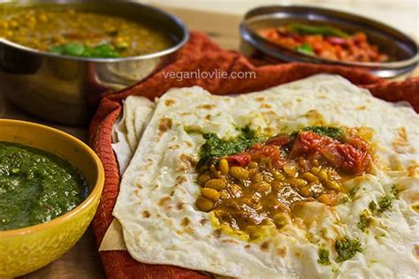Plate of Mauritian food with roti, curry, and rougail