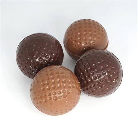 Illustration: balles de golf en chocolat en trois couleurs et cœur fondant