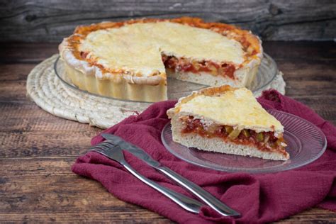 Illustration d'une tarte façon pizza avec une pâte dorée et garniture colorée
