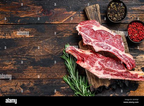 Une belle côte de bœuf crue sur une planche en bois